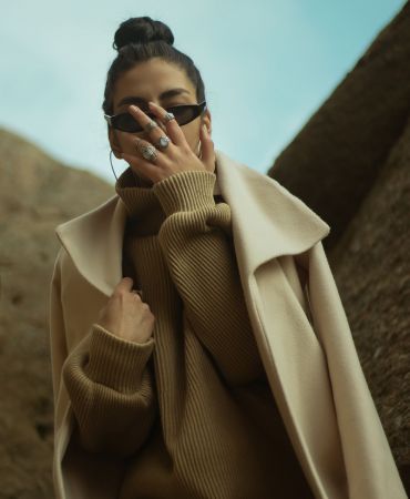 man in brown coat wearing black sunglasses