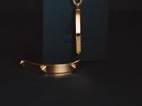 gold-colored pendant necklace